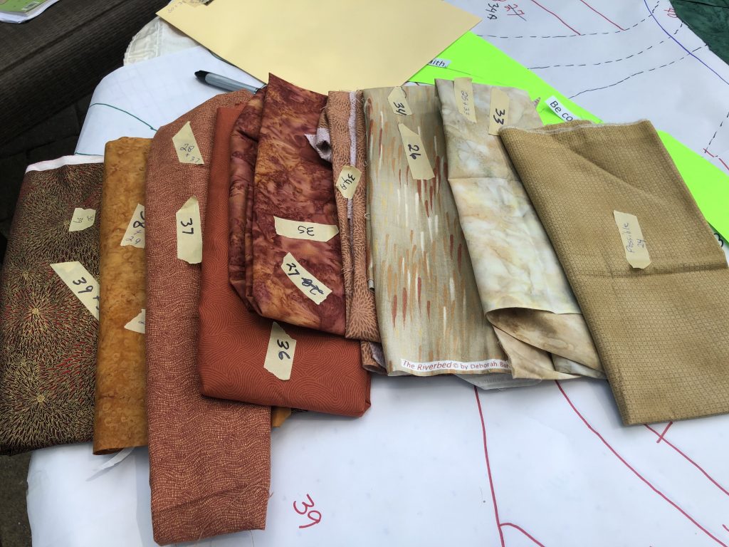 Swatches of fabric that were selected for the quilt in various earth tones