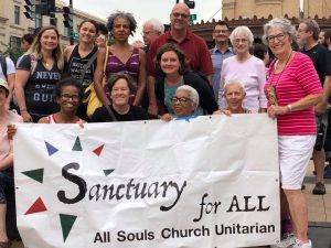 All Souls Members at an anti-ICE demonstration holding the Sanctuary for All Sign with Rev. Rob Hardies
