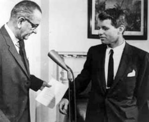 President Lyndon B. Johnson shaking hands with Attorney General Robert F. Kennedy