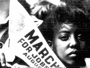 Black Woman holding a sign reading MARCH FOR JOBS