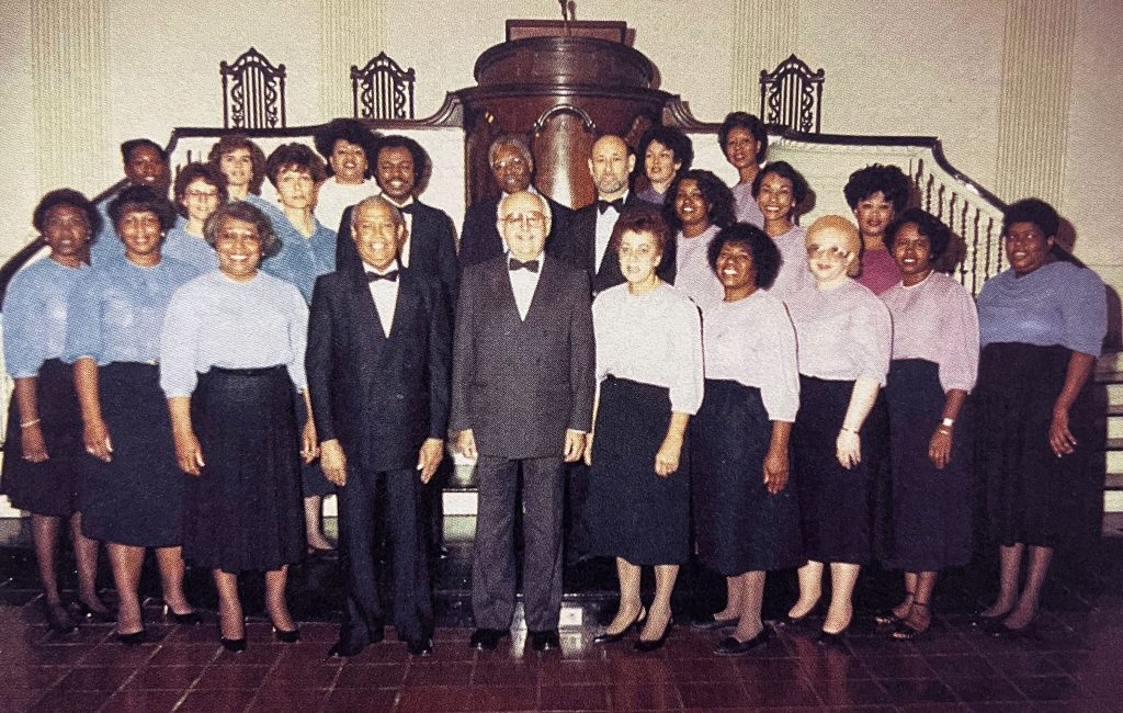 The Jubilee Singers 10th Anniversary Choir members posed together in front of the pulpit.