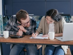 Two people going over a document together.