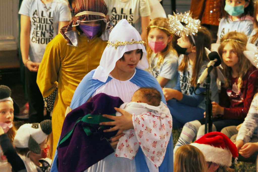 Picture of youth in Christmas Pageant, May, Joseph, and baby Jesus.